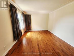 Cornwall apartment for rent - A room with wooden flooring and a window with curtains.