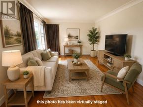 Cornwall apartment for rent - A living room with a couch, a chair, a coffee table, and a television.