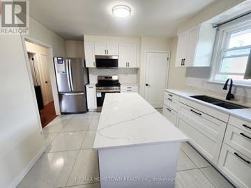 Cornwall apartment for rent - A kitchen with white cabinets and appliances.