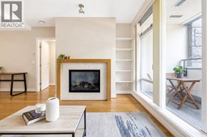 Vancouver apartment for rent - A living room with a fireplace and a grey rug.