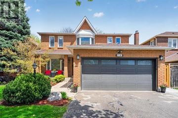 Oakville (Wc Wedgewood Creek) apartment for rent - A house with a grey garage door is for sale.