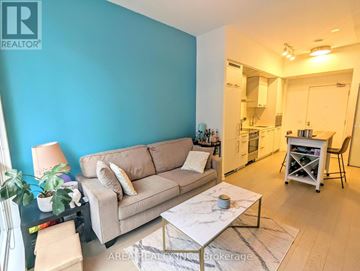 Toronto (Waterfront Communities) condo for rent - A living room with a beige couch and a coffee table.