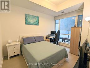 Toronto (Waterfront Communities) condo for rent - A bedroom with a bed, desk, and chair.