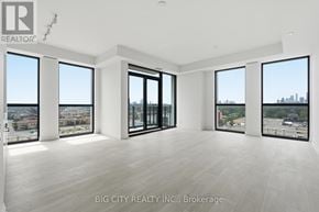 Toronto (Thorncliffe Park) condo for rent - A spacious room with large windows overlooking a cityscape.