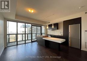 Toronto (Church-Yonge Corridor) condo for rent - A modern kitchen with dark wood floors and stainless steel appliances.
