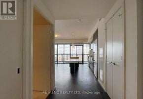 Toronto (Church-Yonge Corridor) condo for rent - A hallway with a table and chairs in the distance.