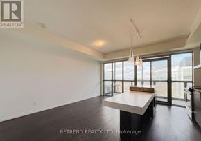 Toronto (Church-Yonge Corridor) condo for rent - A spacious room with a large table and a view of the city through the windows.