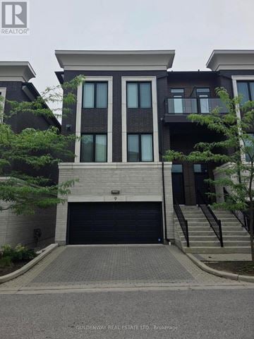 Markham (Unionville) townhouse for rent - A house with a grey front yard and a black garage door.