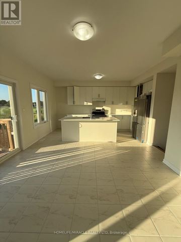 Loyalist (Bath) apartment for rent - A spacious kitchen with white cabinets and a large island.