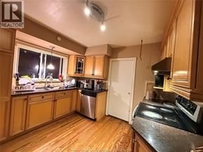 Windsor apartment for rent - A kitchen with wooden cabinets and a stove top oven.