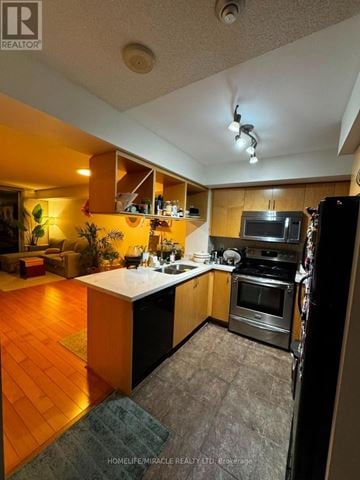 Mississauga (City Centre) condo for rent - A kitchen with wooden cabinets and a white countertop.