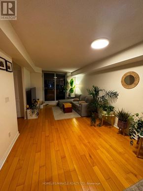 Mississauga (City Centre) condo for rent - A living room with wooden floors and a couch.