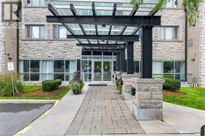 Mississauga condo for rent - The entrance to a building with a glass roof and stone pillars.