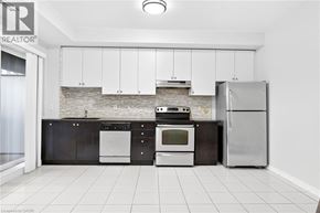 Mississauga condo for rent - A kitchen with a refrigerator, oven, and dishwasher.