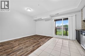 Mississauga condo for rent - A spacious room with wooden flooring and a large window.
