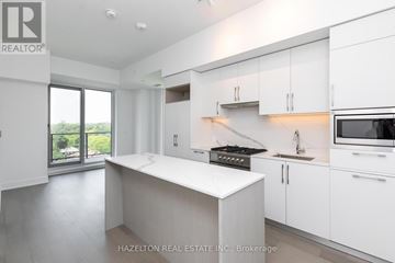 Toronto (Yonge-Eglinton) condo for rent - A modern kitchen with white cabinets and appliances.