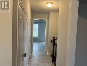 Collingwood apartment for rent - A hallway with a door on the left and a window in the distance.