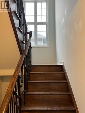 Collingwood apartment for rent - A wooden staircase with a window in the background.