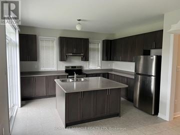 Collingwood apartment for rent - A kitchen with a sink, stove, and refrigerator.