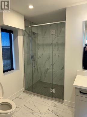 St. Catharines (Ridley) condo for rent - A bathroom with a walk in shower and a toilet.
