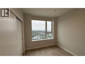 Coquitlam apartment for rent - A room with a window overlooking a cityscape.