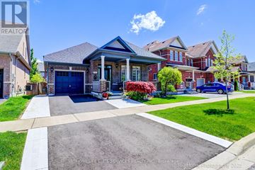 Whitchurch-Stouffville (Stouffville) apartment for rent - A large house with a blue car parked in front.