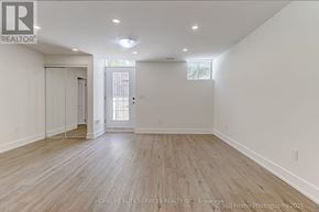 Whitchurch-Stouffville (Stouffville) apartment for rent - A spacious room with wooden flooring and white walls.