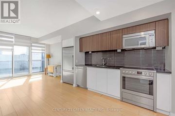 Toronto (Waterfront Communities) condo for rent - A modern kitchen with wooden cabinets and stainless steel appliances.