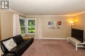 Milton (Tm Timberlea) apartment for rent - A living room with a black couch and a painting on the wall.