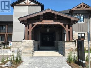Blue Mountains condo for rent - A modern building entrance with a wooden overhang and stone pillars.