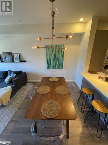 Blue Mountains condo for rent - A modern dining room with a wooden table and chairs.