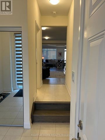 Springwater (Midhurst) apartment for rent - A hallway with a door on the right and a window with blinds on the left.