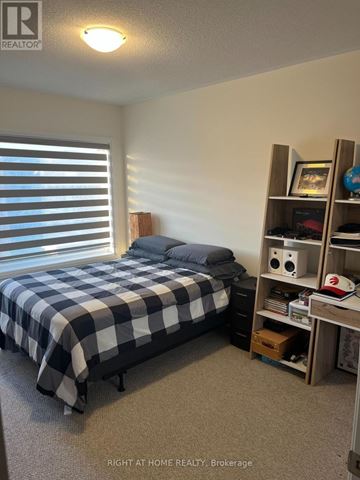 Springwater (Midhurst) apartment for rent - A bedroom with a bed and a shelf with various items on it.