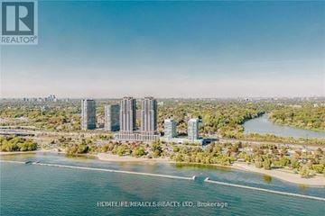Toronto (High Park-Swansea) condo for rent - A real estate company logo is displayed on a scenic aerial view of a coastal city.
