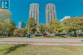 Toronto (High Park-Swansea) condo for rent - A city park with trees and two tall buildings in the background.