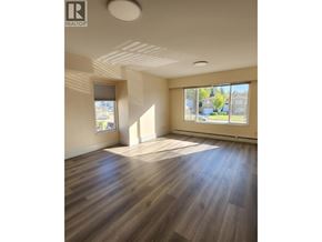 Burnaby apartment for rent - A room with wooden floors and a large window.