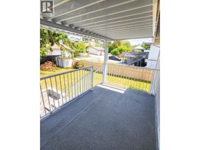 Burnaby apartment for rent - A patio with a metal railing and a grey carpet.