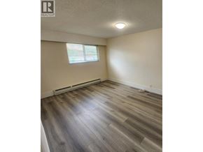 Burnaby apartment for rent - A room with wooden flooring and a window.
