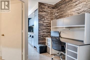 Toronto (Church-Yonge Corridor) condo for rent - A room with a stone wall and a desk with a chair.