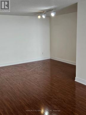 Toronto (Kennedy Park) condo for rent - A room with wooden flooring and white walls.