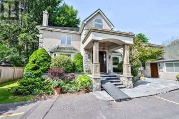 Mississauga (Mineola) apartment for rent - A house with a front yard and a driveway.