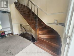 Toronto (Newtonbrook East) apartment for rent - A staircase with a black railing and wooden steps.