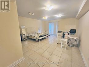 Toronto (Newtonbrook East) apartment for rent - A bedroom with a bed, dresser, and a small table with a lamp.