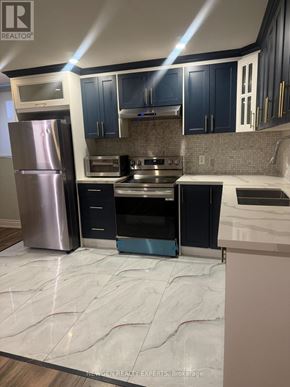 Brampton (Northwest Brampton) apartment for rent - A kitchen with a refrigerator, oven, and microwave.