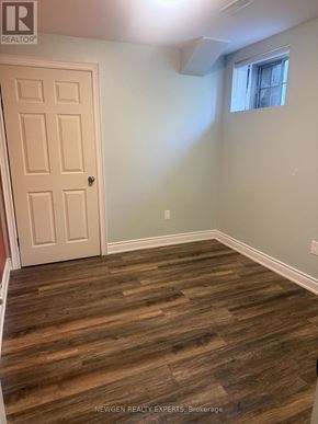 Brampton (Northwest Brampton) apartment for rent - A room with a wooden floor and a white door.