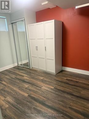 Brampton (Northwest Brampton) apartment for rent - A room with a wooden floor and a white wardrobe.