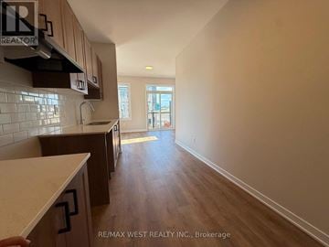 Ottawa townhouse for rent - A kitchen with wooden cabinets and a countertop is shown.