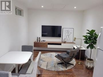 Toronto (Pleasant View) apartment for rent - A modern living room with a white table and grey chairs.