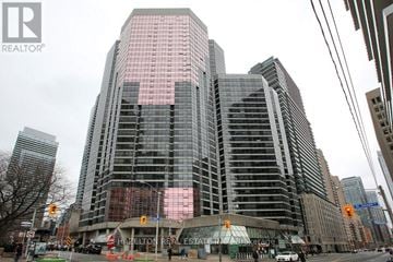 Toronto (Bay Street Corridor) condo for rent - A tall building with a glass facade is under construction.