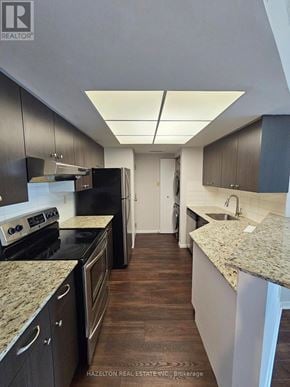 Toronto (Bay Street Corridor) condo for rent - A kitchen with black appliances and brown floors.